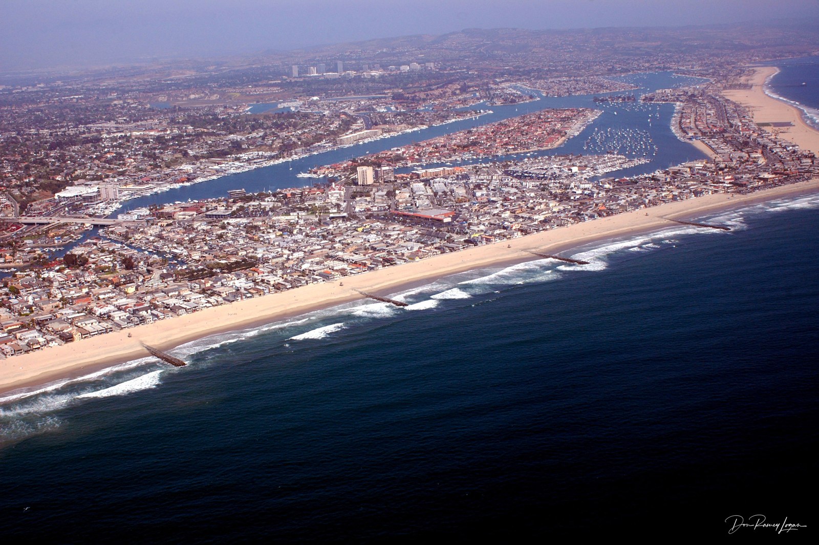 Aerial photograph of Newport Beach, its piers, peninsula and harbor